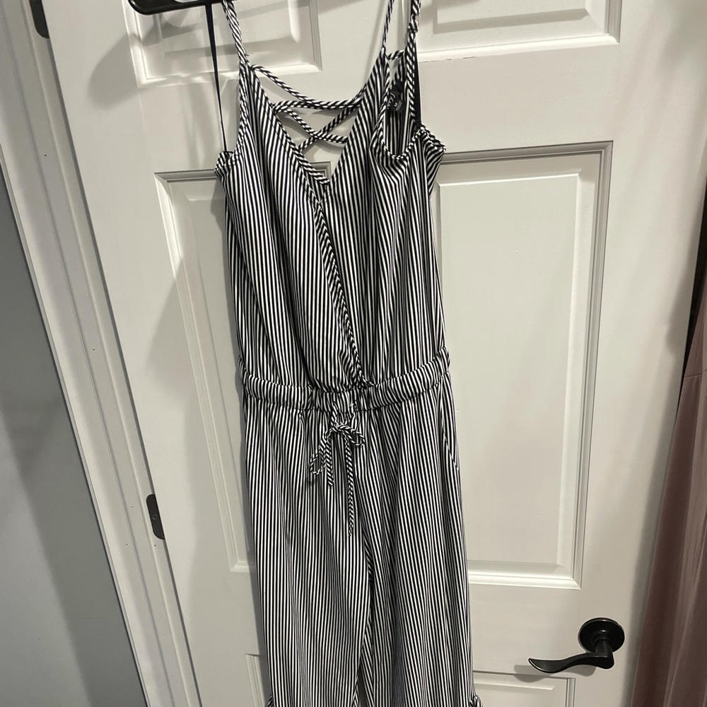 Black and white striped jumpsuit with flared ruffle bottom